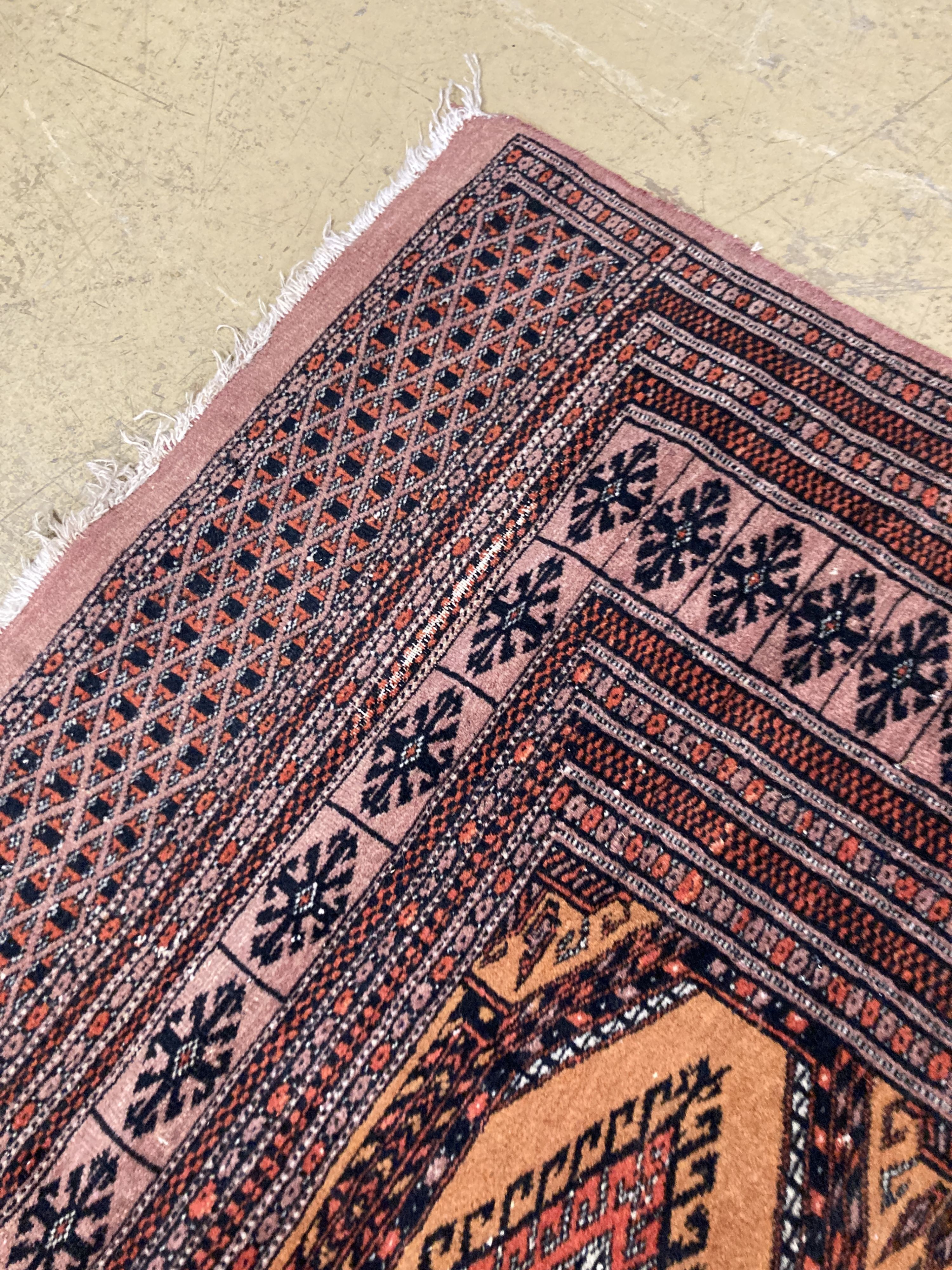 A Bokhara orange ground rug 198 x 125 cms, a smaller Anatolian flat weave rug and Bokhara prayer mat.